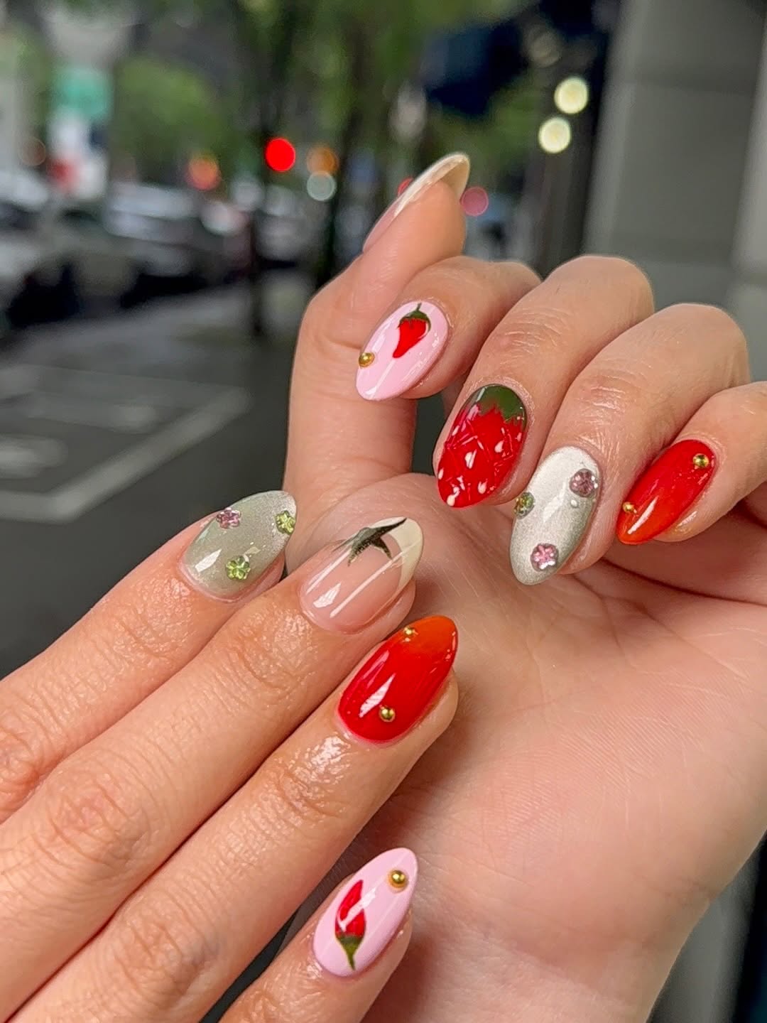 Strawberry and floral 3D nail art on almond-shaped nails, shot on a Belltown Seattle street